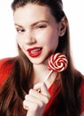 Young pretty brunette girl with red candy posing on white background isolated Royalty Free Stock Photo