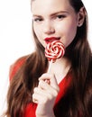 Young pretty brunette girl with red candy posing on white background isolated Royalty Free Stock Photo