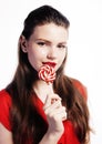 Young pretty brunette girl with red candy posing on white background isolated Royalty Free Stock Photo