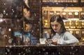 Girl Talking by Phone in Cafe