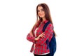 Young pretty brunette student woman with blue backpack on her shoulder looking at the camera and smiling isolated on Royalty Free Stock Photo