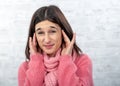 Young and pretty brunette woman with earache