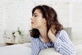 Young pretty brunette woman in her bedroom sitting at window, happy smiling lifestyle people concept Royalty Free Stock Photo