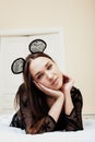 Young pretty brunette woman wearing lace mouse ears, laying waiting dreaming in bed Royalty Free Stock Photo