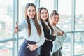 Young pretty business girls show a good gesture. Royalty Free Stock Photo