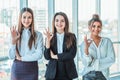 Young pretty business girls show a good gesture. Dressed in classic clothes, smiling copy space Royalty Free Stock Photo