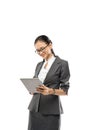 Young pretty business woman holding tablet wearing suit