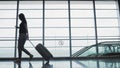 Young Pretty Businesswoman Using a Smartphone at Airport While Waiting Her Queue For Registration, Travelling Concept Royalty Free Stock Photo