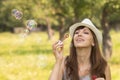 Young pretty caucasian woman having fun with blowing bubbles Royalty Free Stock Photo