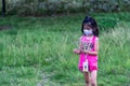 Young Pretty child playing picking up flowers in a farm while wearing mask Royalty Free Stock Photo