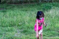 Young Pretty child playing picking up flowers in a farm while wearing mask Royalty Free Stock Photo