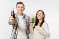 Young pretty couple man and woman holding green detox smoothies, cola in glass bottle isolated on white background