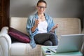 Young pretty european woman with glasses psychologist coach holds an online session on the internet, remote work from home, online Royalty Free Stock Photo