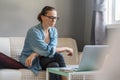 Young pretty european woman with glasses psychologist coach holds an online session on the internet, remote work from home, online