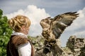 Young pretty Falconer with his falcon, used for falconry,