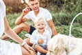 Young cute family on picnic with dog Royalty Free Stock Photo