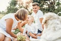 Young cute family on picnic with dog Royalty Free Stock Photo