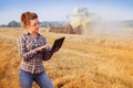 Young pretty farmer girl in glasses in wheat field