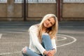 Young pretty fashionable blonde woman dressed in ripped jeans Royalty Free Stock Photo