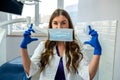 Young pretty female dentist stomatology in uniform and gloves at workplace cabinet Royalty Free Stock Photo