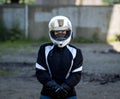 Young pretty female motorcyclist with full face helmet