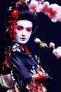 young pretty geisha in kimono with sakura and decoration on blac Royalty Free Stock Photo