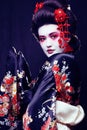 young pretty geisha in kimono with sakura and decoration on blac Royalty Free Stock Photo