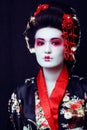 young pretty geisha in kimono with sakura and decoration on blac Royalty Free Stock Photo