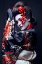 Young pretty geisha in kimono with sakura and