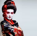 young pretty geisha in kimono with sakura and red decoration des Royalty Free Stock Photo