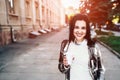 Pretty young girl with coffee walking on the street