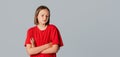 Young pretty girl with crossed arms looks away like she is very disappointed, very sad or doesn`t want to hear anything, dressed Royalty Free Stock Photo