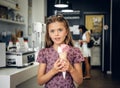 A girl eating ice cream in a cafe. Royalty Free Stock Photo