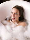 Young pretty girl enjoying bath with foam Royalty Free Stock Photo