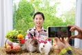 Young pretty girl live streaming rabbit life by smartphone at her farm, selective focus at a girl Royalty Free Stock Photo