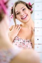 Young pretty girl looking her reflection in mirror Royalty Free Stock Photo