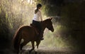 Young girl riding a horse