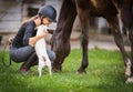 Young pretty girl riding a horse with backlit leaves behind