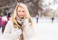 Young and pretty girl skating on outdoor ice-rink