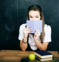 Young pretty girl student in classroom at blackboard doing homework Royalty Free Stock Photo