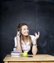 Young pretty girl student in classroom at blackboard doing homework smiling Royalty Free Stock Photo