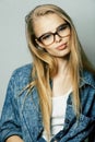 Young pretty girl teenager in glasses on white isolated blond hair modern hipster