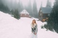 The young pretty girl waits for her lover in the middle of the mountains covered with snow Royalty Free Stock Photo