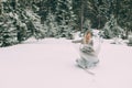 The young pretty girl waits for her lover in the middle of the mountains covered with snow Royalty Free Stock Photo