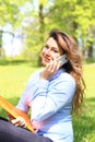 Young pretty girl working on laptop outdoor, lying on grass, caucasian 21 years old