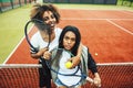 Young pretty girlfriends hanging on tennis court, fashion stylish dressed swag, best friends happy smiling together Royalty Free Stock Photo