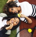 young pretty girlfriends hanging on tennis court, fashion stylish dressed swag, best friends happy smiling together Royalty Free Stock Photo