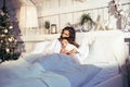 Young pretty girls in bed at Christmass morning, happy family smiling lifestyle at holiday Royalty Free Stock Photo