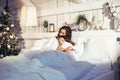 Young pretty girls in bed at Christmass morning, happy family smiling lifestyle at holiday Royalty Free Stock Photo