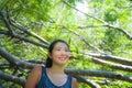 Young pretty and happy Asian Chinese woman taking a walk excursion trip on tropical mountain enjoying nature smiling cheerful in h Royalty Free Stock Photo
